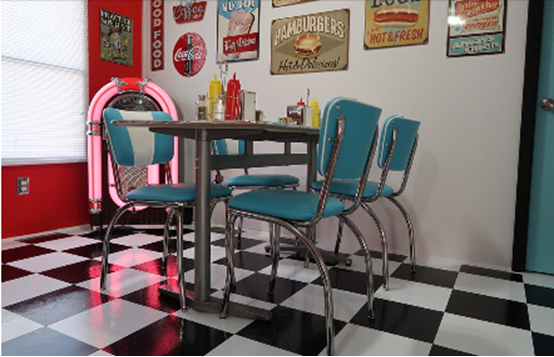 Retro dining set with teal chairs, chrome details, and a classic black and white diner style floor